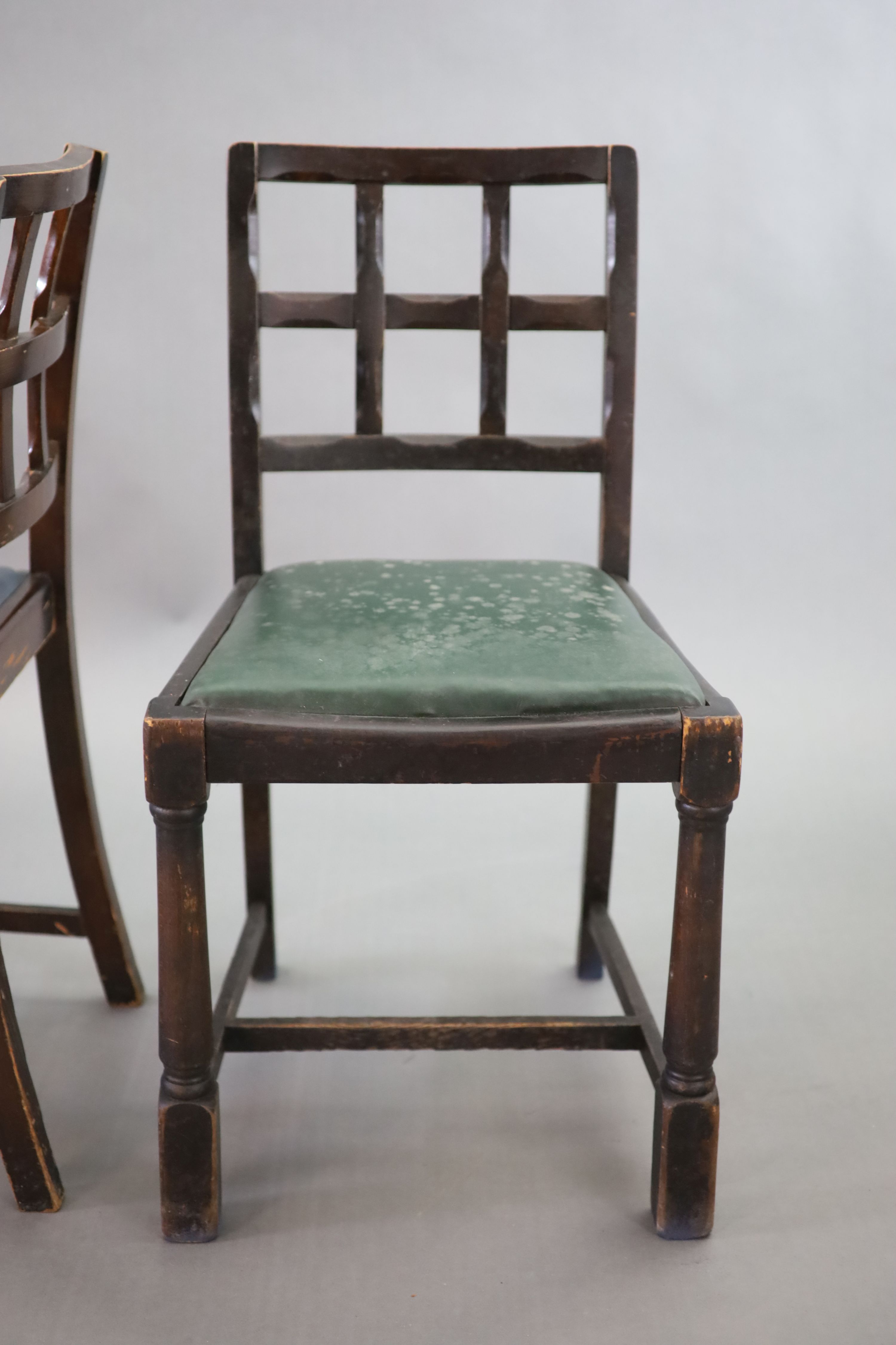 A set of twelve stained beech and oak dining chairs, with cross frame backs and drop-in seats, on turned and squared legs